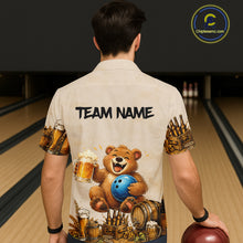 Load image into Gallery viewer, Person wearing a shirt with a bear holding a bowling ball and beer mugs design, standing in a bowling alley.