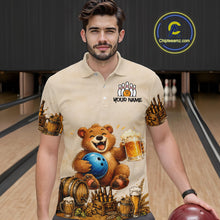 Load image into Gallery viewer, Man wearing a shirt with a bear holding a bowling ball and beer design in a bowling alley.