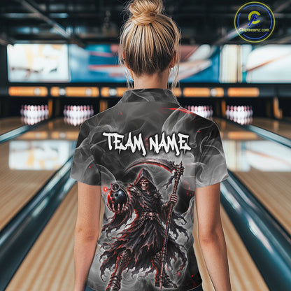 A woman viewed from behind wearing a custom bowling shirt with a dark grim reaper graphic and the text 'TEAM NAME' on the back, standing in a bowling alley.