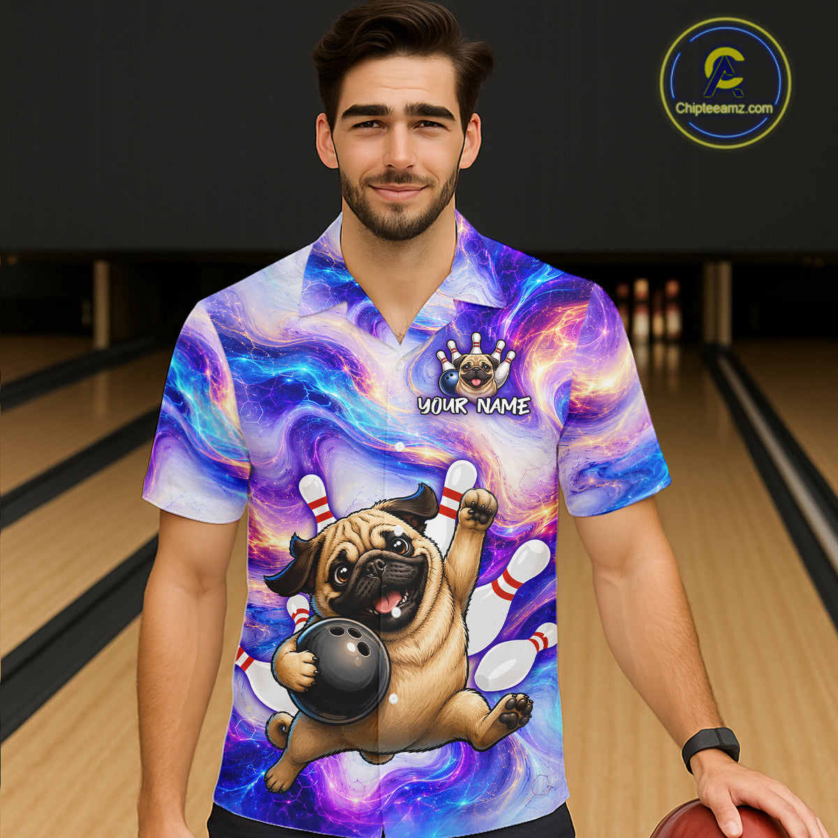 Person wearing a colorful bowling-themed shirt with a pug design in a bowling alley.