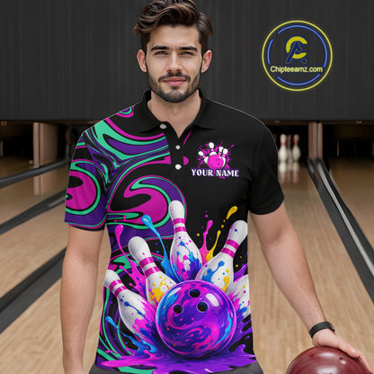 Man wearing a custom bowling-themed shirt with colorful design and bowling ball, standing in a bowling alley.