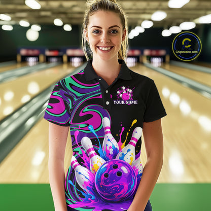 Person wearing a colorful bowling shirt with a design of a bowling ball and pins in a bowling alley.