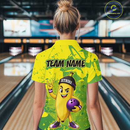 A woman wearing custom yellow banana bowling polo shirt back view featuring a bowling ball and green camouflage pattern, displaying Team Name, at the bowling alley
