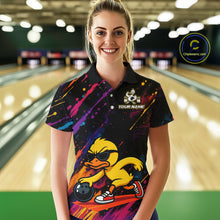 Load image into Gallery viewer, A woman stands in a bowling alley wearing a black short-sleeve polo shirt with a colorful graphic of a yellow duck bowling. The shirt features a galaxy print on the upper chest and a large yellow duck illustration with sunglasses, a bowling ball, and the text 'YOUR NAME' on the front.