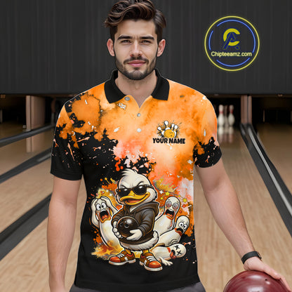 A man wearing a custom bowling-themed polo shirt with a cartoon duck mascot and orange/black splatter design, standing in a bowling alley. 