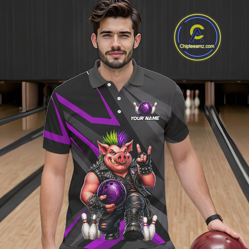A man wearing a custom black and purple bowling-themed polo shirt with a graphic of a pig bowling ball, standing in a bowling alley. The shirt features a purple and black geometric pattern and a large cartoon pig graphic holding a purple bowling ball.