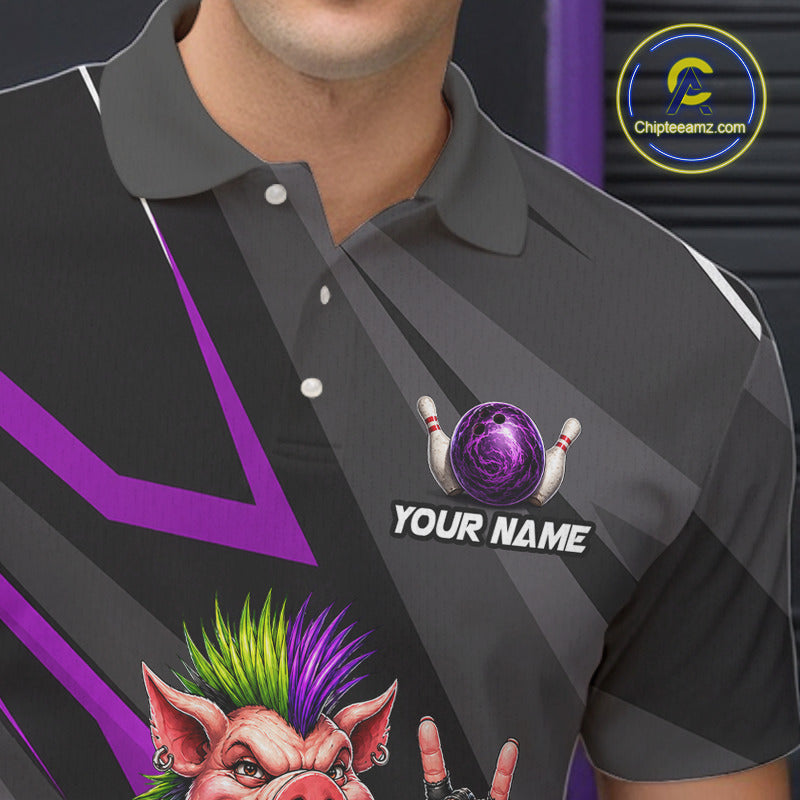 A close-up of a man wearing a dark gray and black short-sleeve polo shirt with purple graphic stripes, a bowling-themed chest print with a purple bowling ball and pins, and a cartoon pig graphic at the bottom. The text 'YOUR NAME' is printed on the chest.