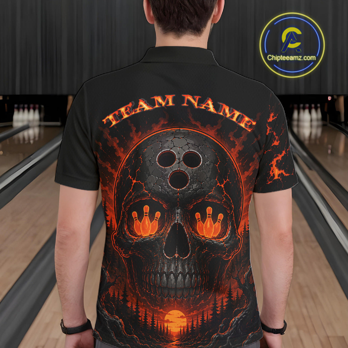 Person wearing a black bowling shirt with a skull and bowl design in a bowling alley.