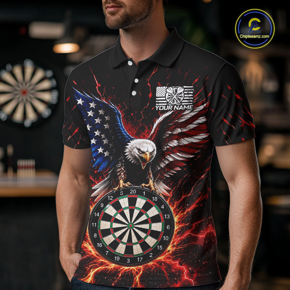 A man wearing a black short-sleeve polo shirt with a large patriotic eagle and dartboard graphic print, featuring red, white, and blue flames and stars. The shirt has a custom name patch on the chest that reads 'YOUR NAME'.