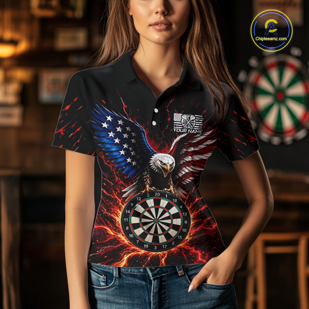 A man wearing a custom patriotic eagle dart polo shirt featuring a bald eagle, an American flag, and a flaming dartboard in a professional dart room.