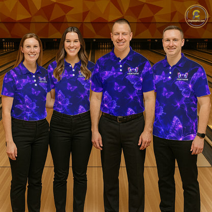 Four people standing together in a bowling alley wearing matching purple and blue patterned polo shirts with black pants. A bowling lane and wooden floor are visible in the background