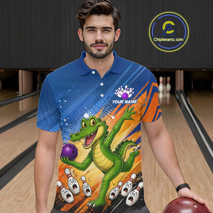 A man wearing a custom bowling-themed short-sleeve polo shirt with a cartoon alligator graphic, standing in a bowling alley holding a bowling ball. The shirt features a blue and orange striped background with a green alligator catching a purple bowling ball.