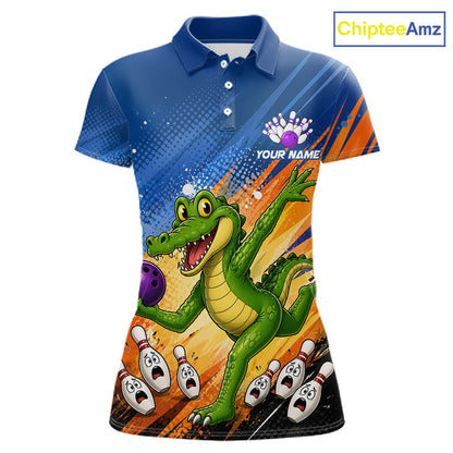 A short-sleeve polo shirt with a vibrant all-over bowling-themed graphic featuring a green cartoon alligator holding a purple bowling ball, bowling pins, and orange and blue abstract background stripes. The shirt has a blue collar and sleeve, white buttons, and 'YOUR NAME' printed on the chest.