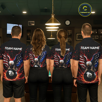 Four people wearing matching bowling shirts with eagle and ball design in a bowling alley.