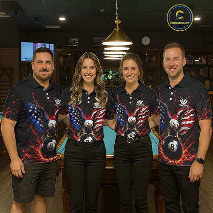 Four people wearing matching bowling shirts with an eagle and ball design in a bowling alley.