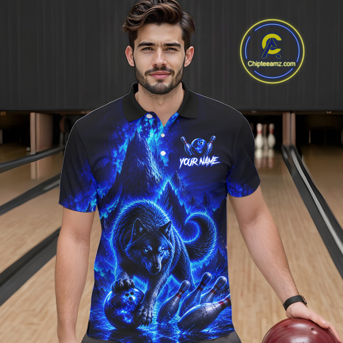 Man wearing a black polo shirt with blue wolf design in a bowling alley.