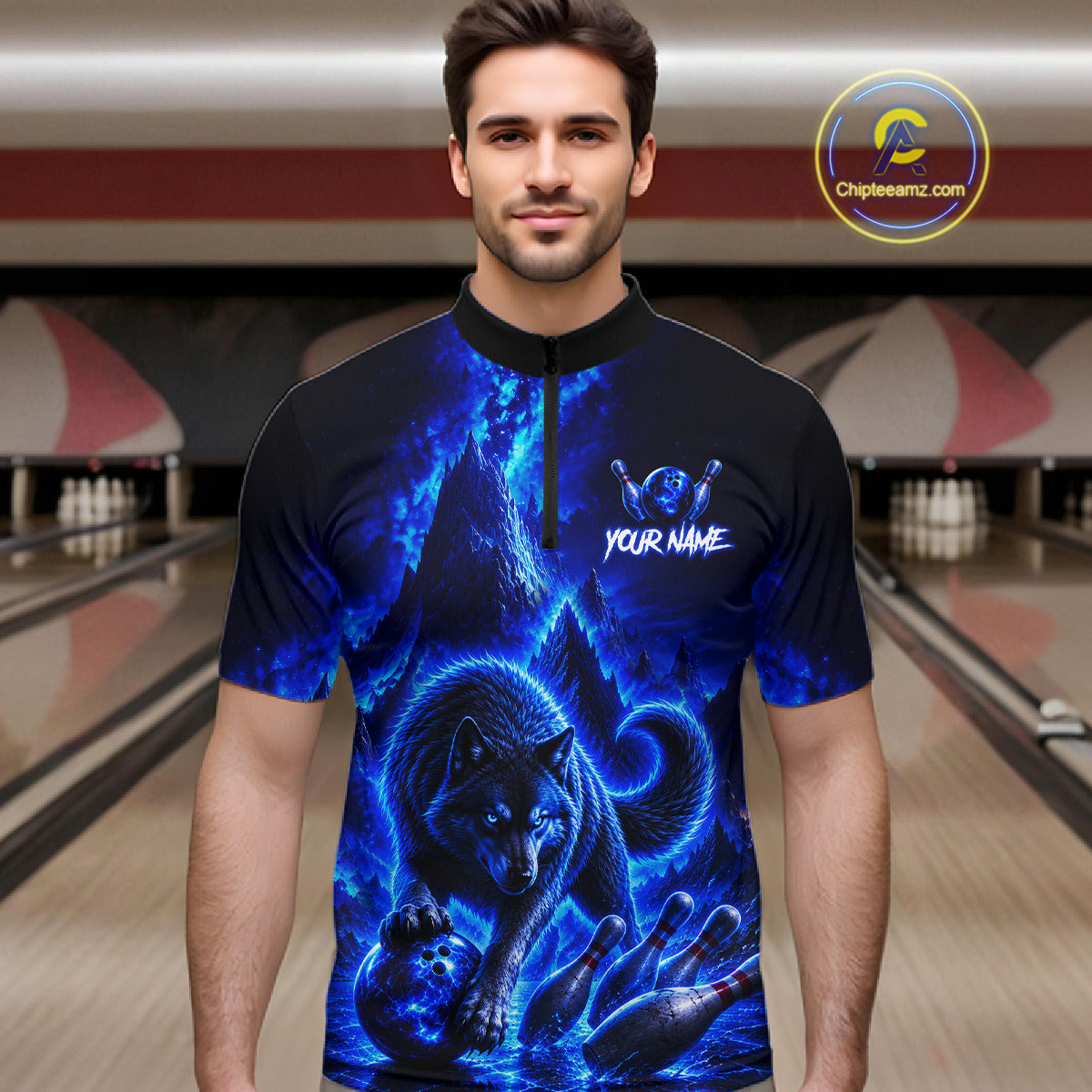 Man wearing a blue wolf design shirt in a bowling alley.