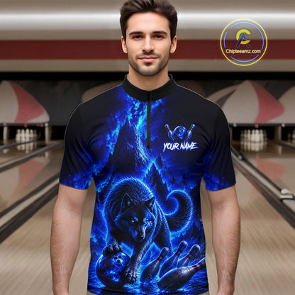 Man wearing a blue wolf design shirt in a bowling alley.