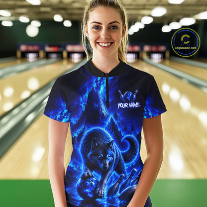 Person wearing a blue wolf-themed shirt in a bowling alley