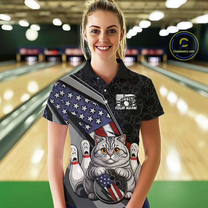 Woman wearing custom black patriotic cat bowling polo shirt front view featuring a cute cartoon feline, American flag and bowling ball, displaying Your Name, at the bowling alley