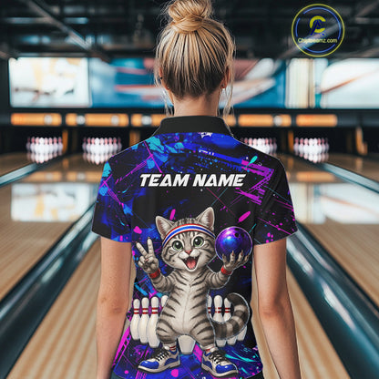 Person wearing a colorful bowling shirt with a cat design and 'TEAM NAME' text in a bowling alley.