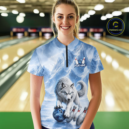 Person wearing a bowling shirt with a wolf design in a bowling alley.