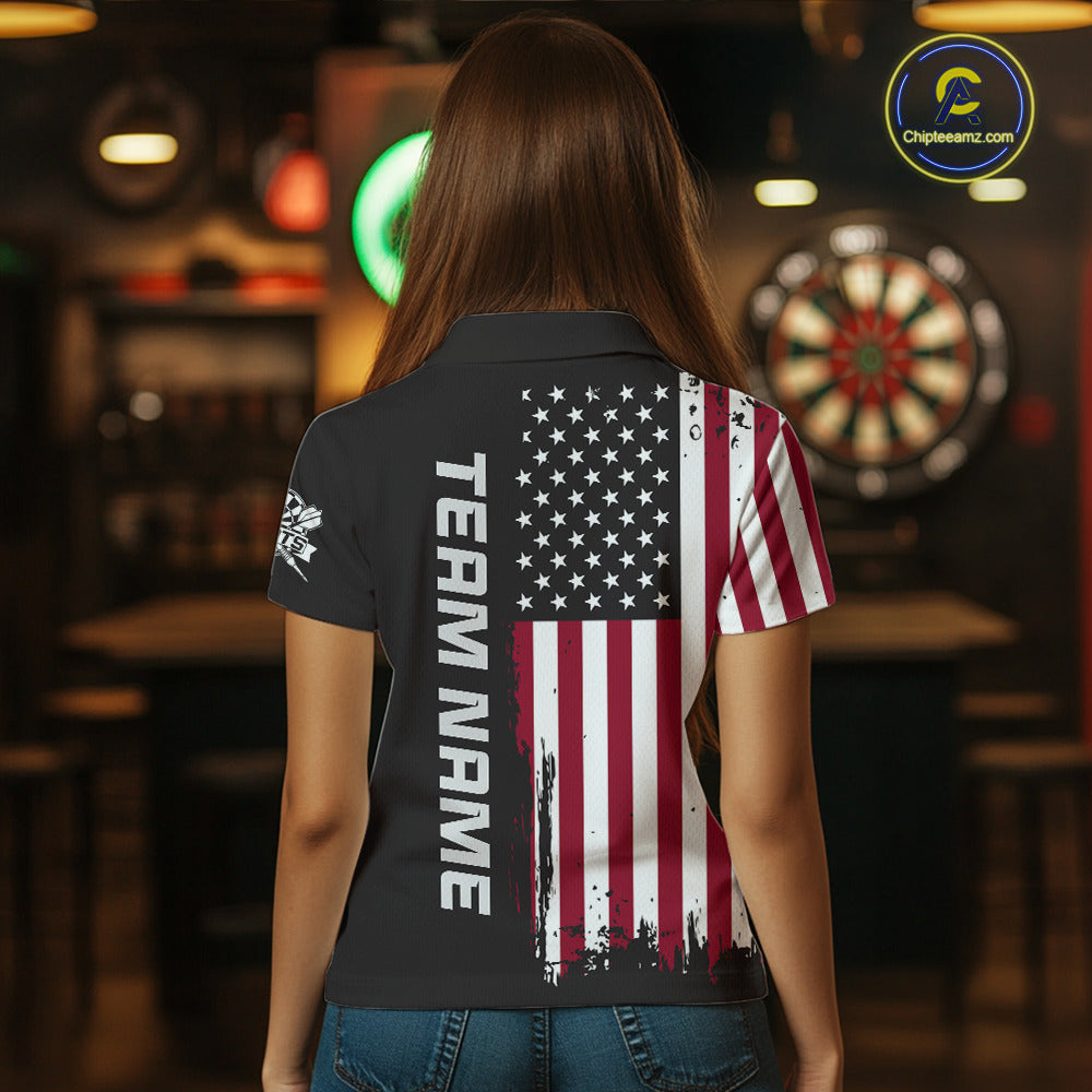 Back view of a woman wearing a custom brown dart polo with personalized team name and a distressed American flag graphic in a professional dart room.