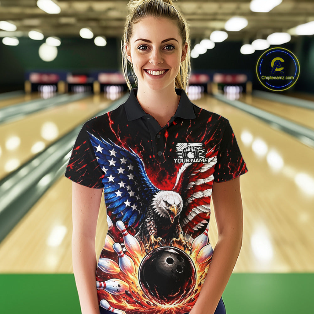 Woman wearing a bowling shirt with an eagle design in a bowling alley.
