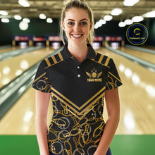 Load image into Gallery viewer, Female model wearing a custom black gold bowling polo shirt front view featuring a golden winged bowling ball emblem, geometric line pattern and premium black gold design at the bowling alley