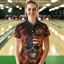 Load image into Gallery viewer, Woman wearing a black bowling shirt with a skull and American flag design in a bowling alley.