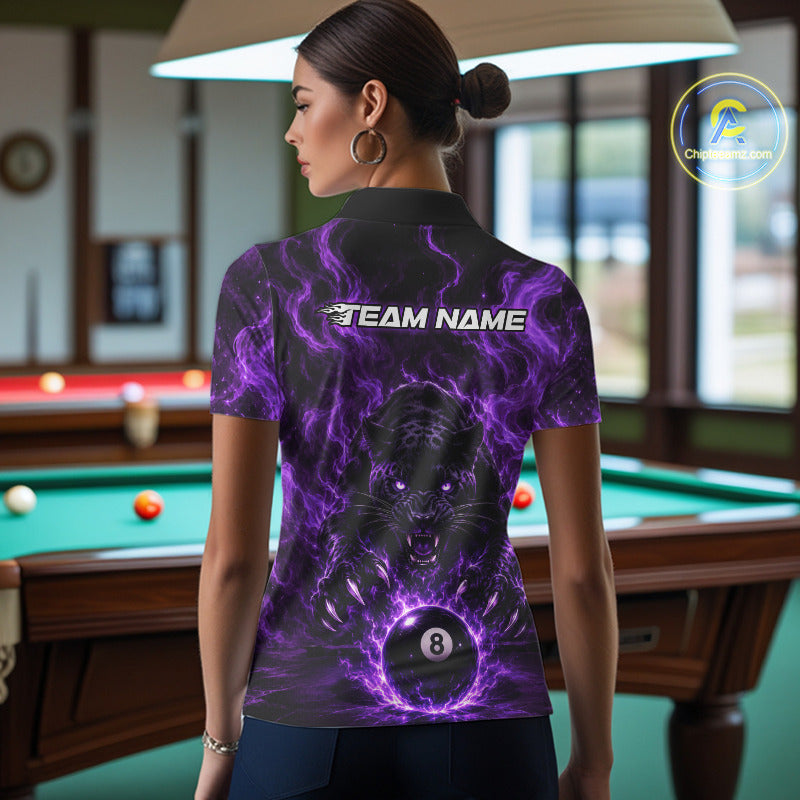 A woman stands in a billiards room wearing a short-sleeve polo shirt from the back. The shirt features a black and purple electric storm graphic with a tiger design and the text 'TEAM NAME'.
