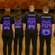 Load image into Gallery viewer, Four people standing in a bowling alley, viewed from behind, wearing black short-sleeve shirts with a custom graphic print of a raccoon and bowling ball in a purple and blue cosmic design. The shirts also feature 'TEAM NAME' text printed on the upper back.