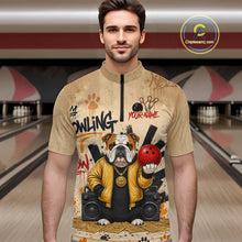 Load image into Gallery viewer, A man wearing a beige short-sleeve zip-front shirt with a bowling-themed graphic print featuring an bulldog in a yellow jacket holding a red bowling ball, set against a bowling alley background. A circular 'Chipeeamz.