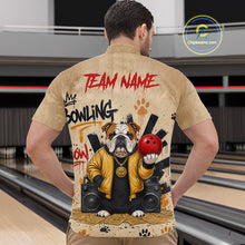 Load image into Gallery viewer, A man viewed from behind wearing a tan short-sleeve button-up shirt with a large bowling-themed graphic on the back. The print includes red 'TEAM NAME' text, black and red 'BOWLING' lettering, a bulldog holding a red bowling ball, speakers, and paw prints.