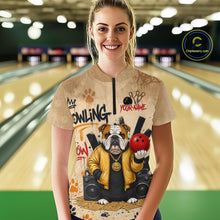 Load image into Gallery viewer, A woman stands in a bowling alley wearing a beige graphic t-shirt featuring a bulldog holding a red bowling ball with the words 'MY BOWLING YOUR NAME'. The background shows blurred bowling lanes, and a 'Chilewich.