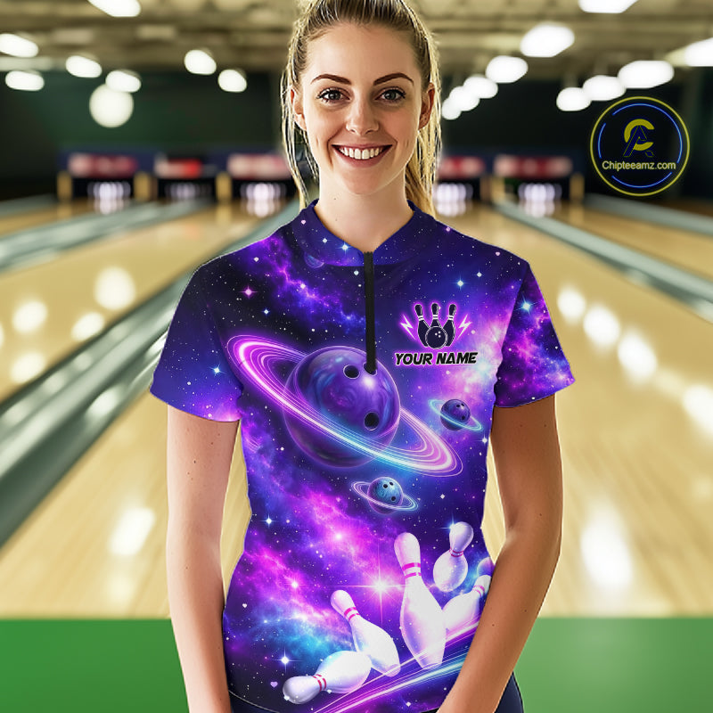 Woman wearing a colorful bowling shirt with galaxy design and personalized text in a bowling alley.