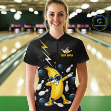 Load image into Gallery viewer, Person wearing a black bowling-themed shirt with a banana character in a bowling alley.