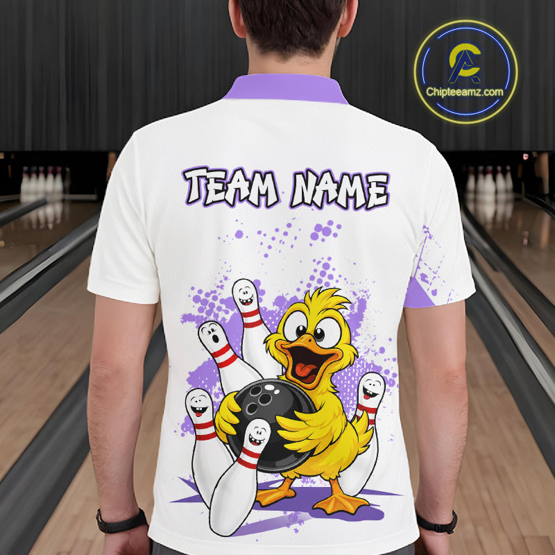 A man viewed from behind wearing a white short-sleeve bowling t-shirt with a purple collar, featuring a cartoon yellow duck holding bowling pins and a bowling ball, with the text 'TEAM NAME' printed on the back. The background shows a bowling alley with lanes and pins.