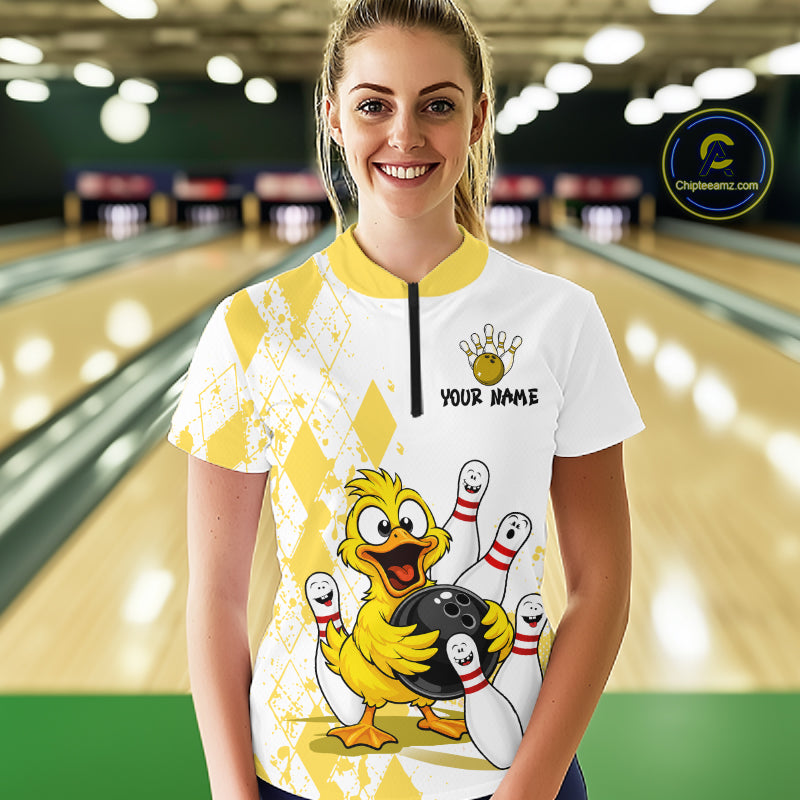 A woman stands in a bowling alley wearing a white and yellow bowling-themed custom jersey with a cartoon duck holding a bowling ball and the text 'YOUR NAME' on the chest. A circular 'Chilewich.