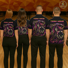 Load image into Gallery viewer, Four people wearing matching shirts with a team name on a bowling alley.