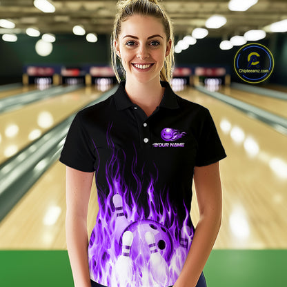 Woman wearing a black bowling shirt with a purple flame design in a bowling alley.