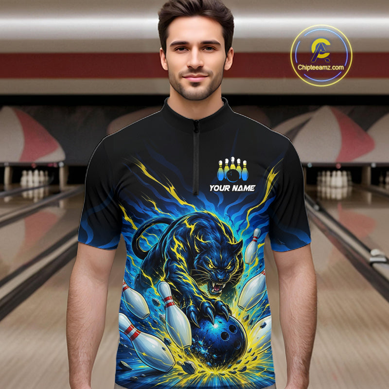 Man wearing a black bowling shirt with a panther design in a bowling alley.