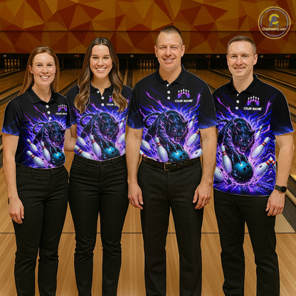 Four people wearing matching bowling shirts in a bowling alley.