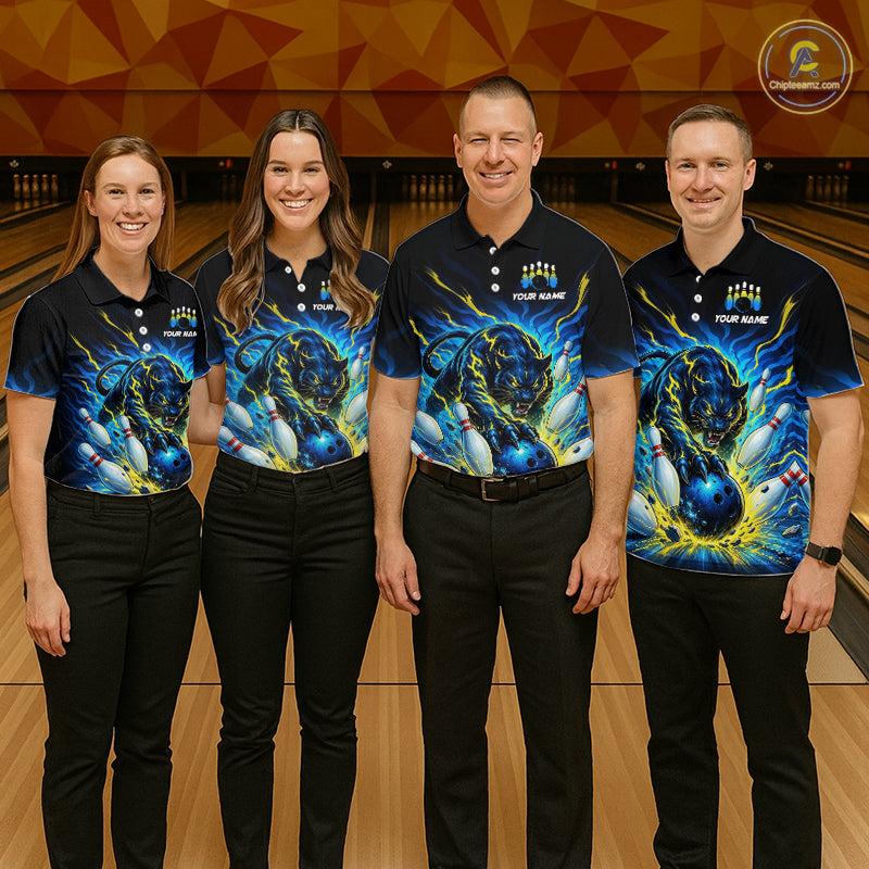 Four people wearing matching bowling shirts with a dragon design on a bowling alley.