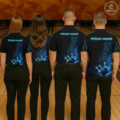 Four people standing in a bowling alley, viewed from behind, wearing matching dark navy short-sleeve shirts with a blue flame graphic and the text 'TEAM NAME' across the upper back. The shirts also feature a bowling pin and bowling ball design near the lower back.