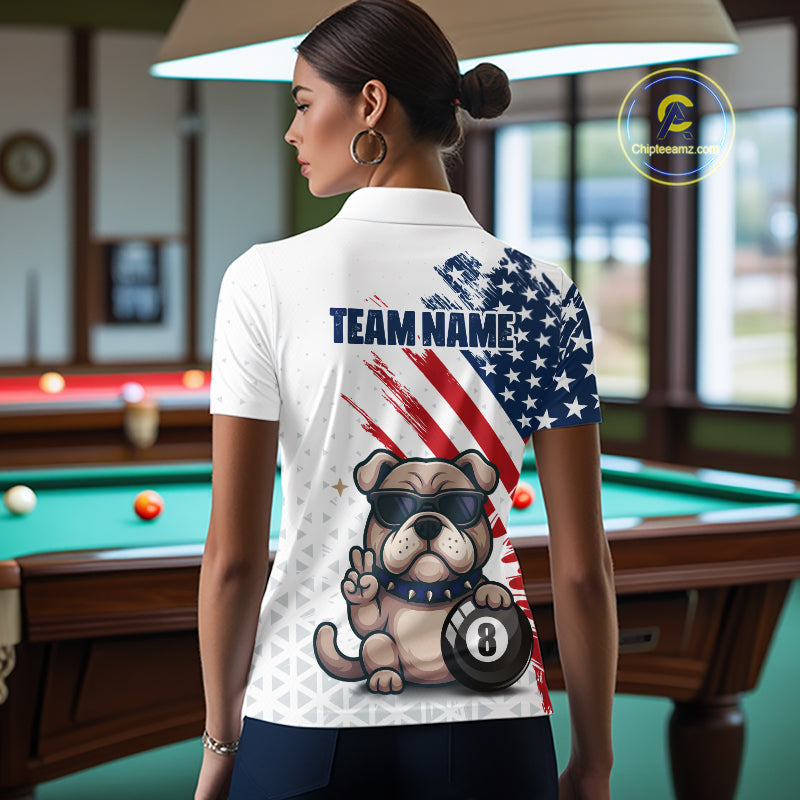 Person wearing a white polo shirt with a dog and American flag design in a pool hall.