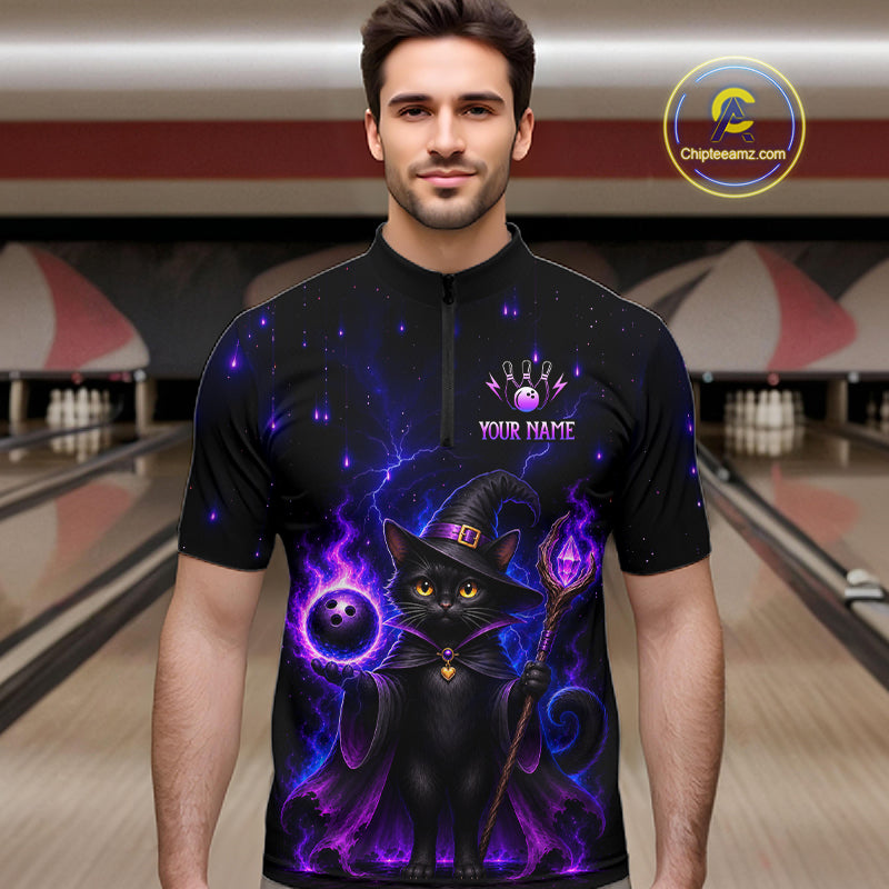 A man wearing a black short-sleeve quarter-zip shirt with a purple and black witch cat graphic, standing in front of a blurred bowling alley background. The shirt features a purple glowing cat in a witch hat, purple lightning effects, and a customizable chest graphic that reads 'YOUR NAME'.