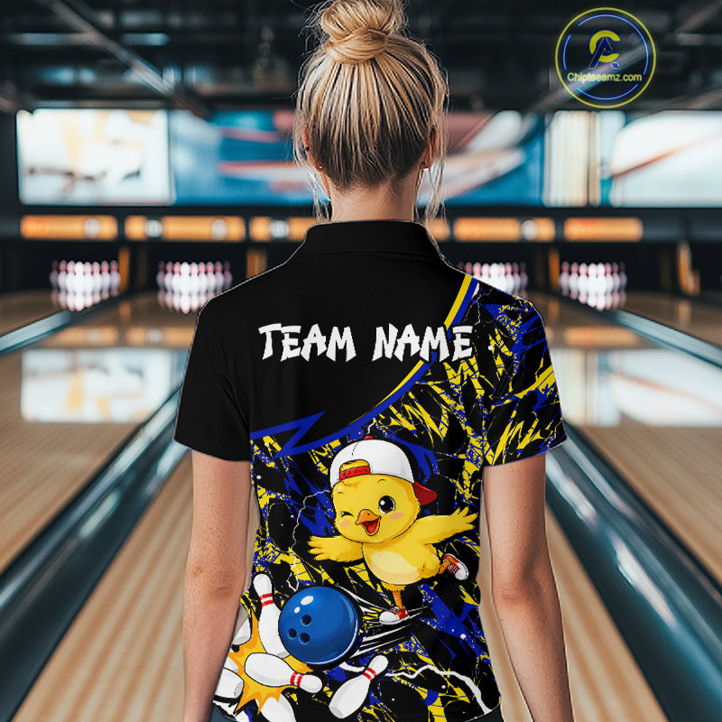 Person wearing a colorful bowling shirt with a chicken design in a bowling alley.