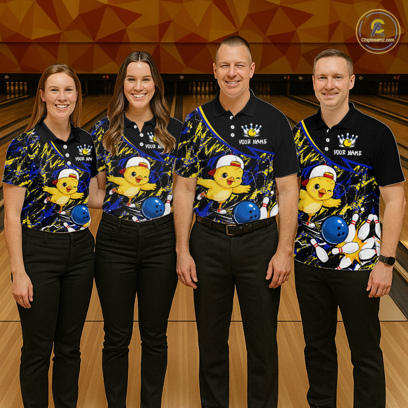 Four people wearing matching bowling shirts with a chicken and ball design on a bowling alley.