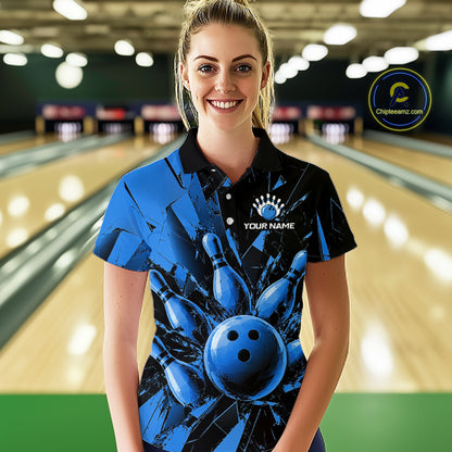 A woman stands in a bowling alley wearing a custom blue and black bowling-themed polo shirt with a bowling pin and ball graphic, and a white placeholder logo on the chest.